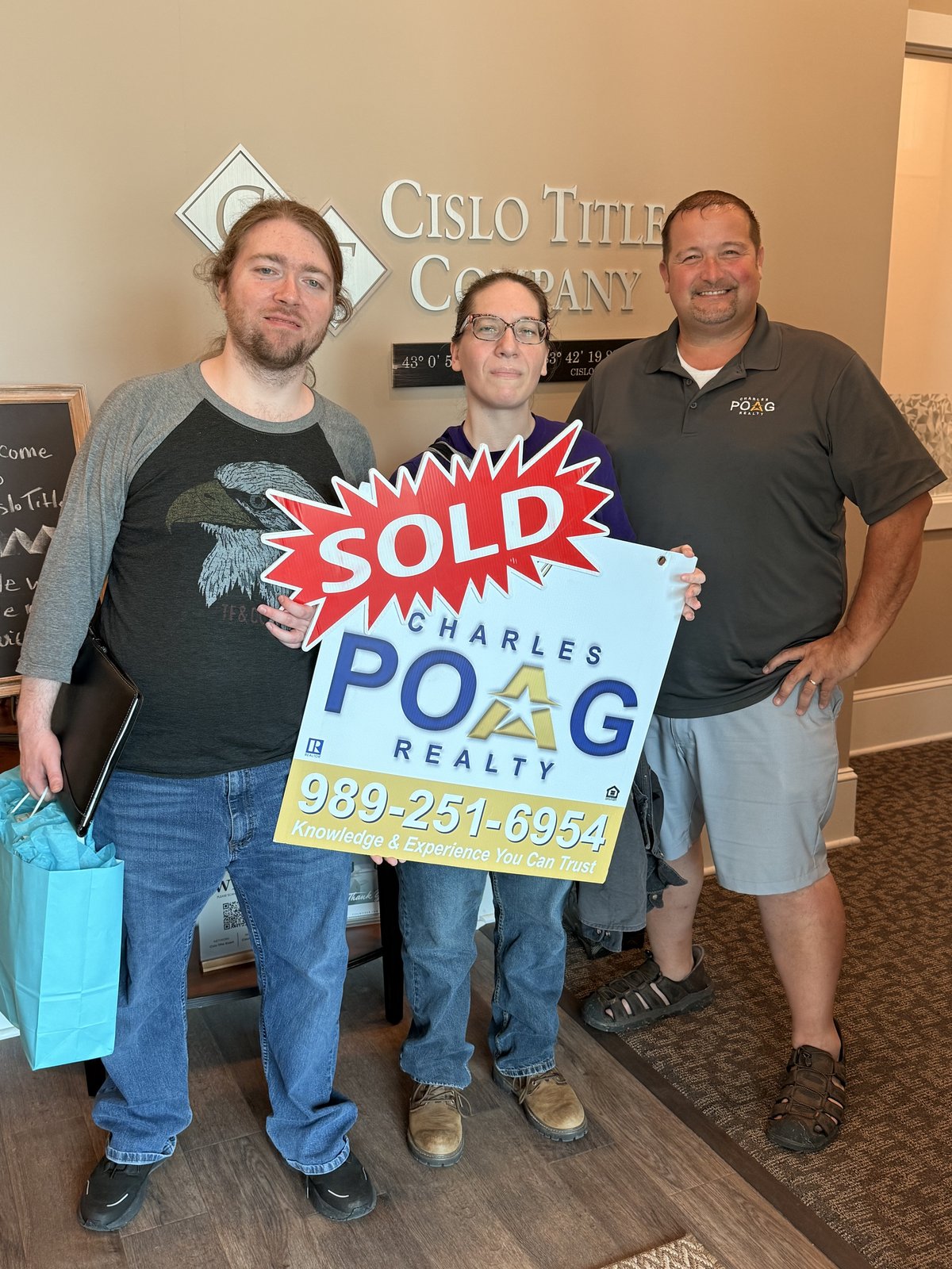 Charles Poag with clients at closing