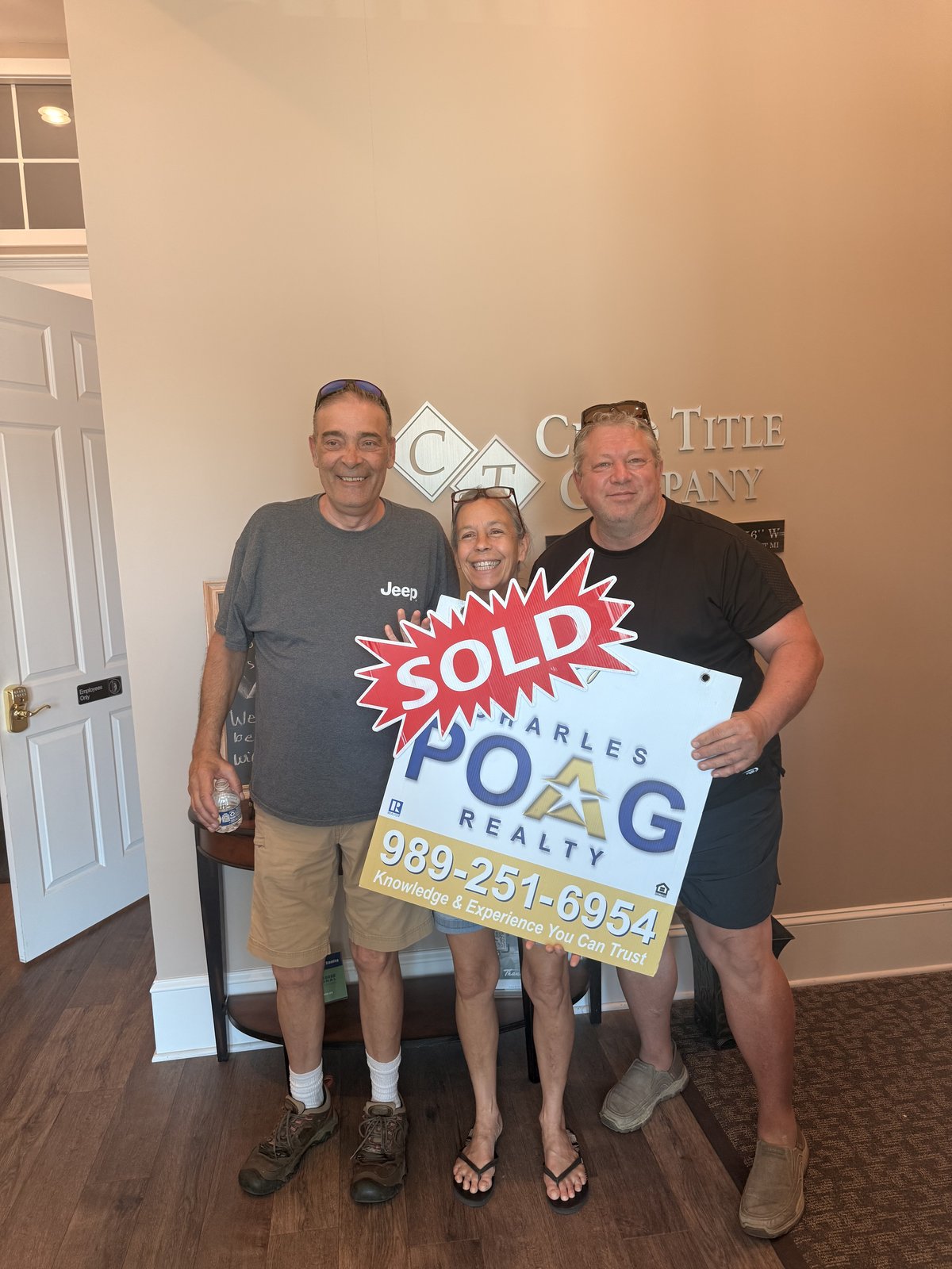 Charles Poag with clients at closing